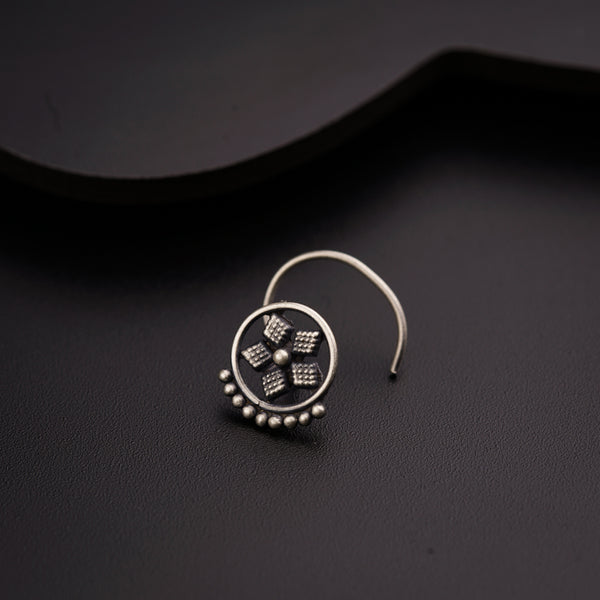 a close up of a pair of earrings on a black surface