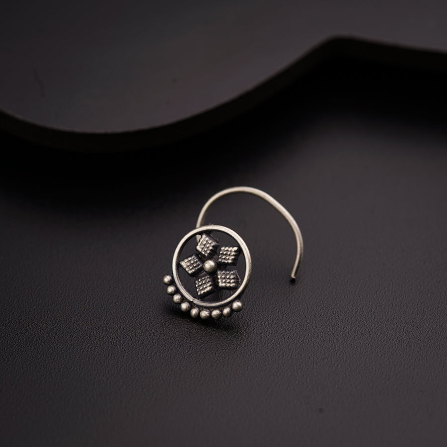 a close up of a pair of earrings on a black surface