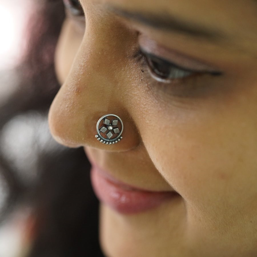 a close up of a person with a nose piercing