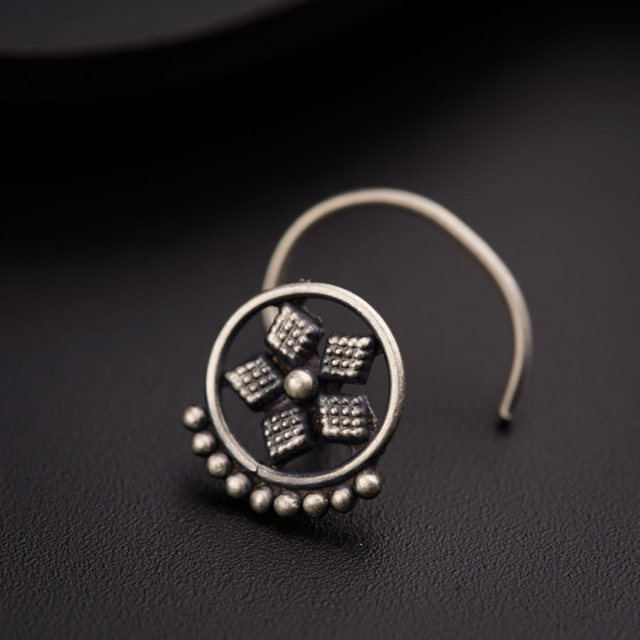 a close up of a pair of earrings on a table
