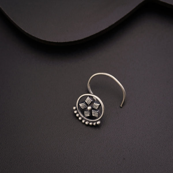 a close up of a pair of earrings on a black surface