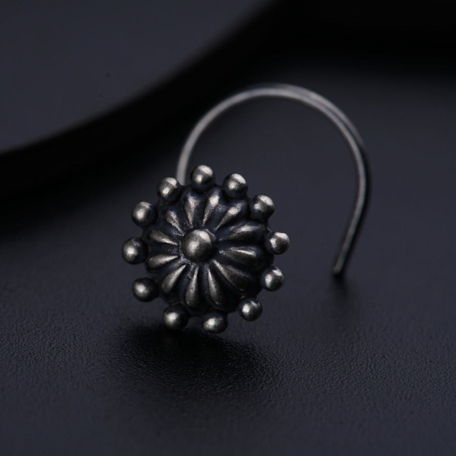 a close up of a metal object on a black surface