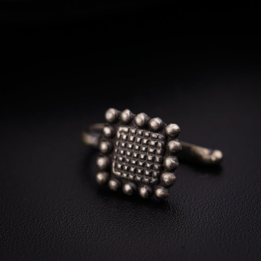 a close up of a metal object on a black surface