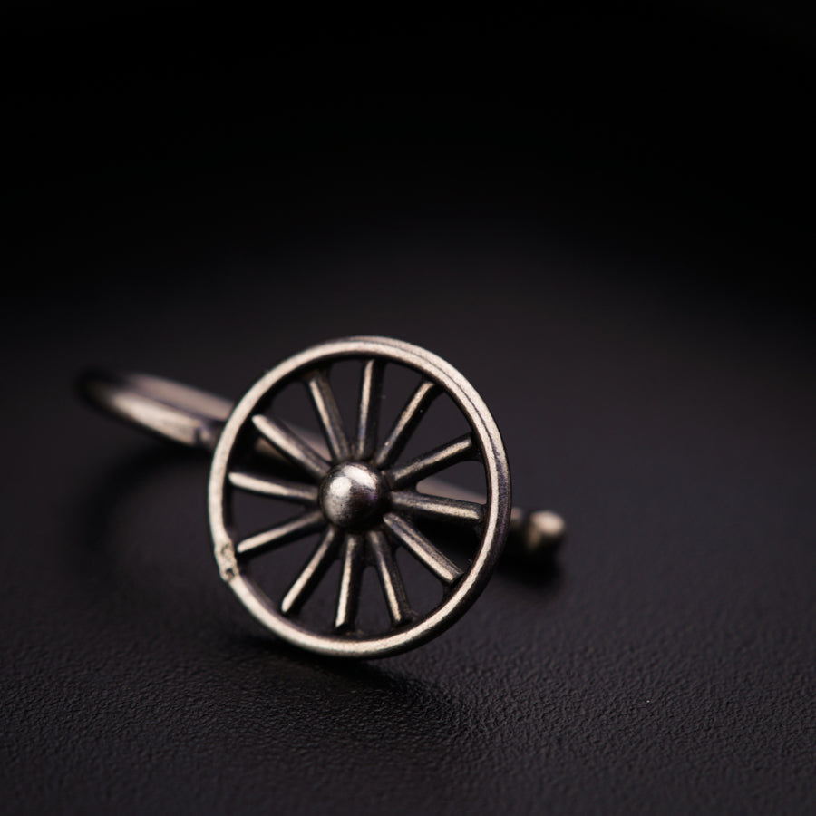 a silver ring with a wheel on it
