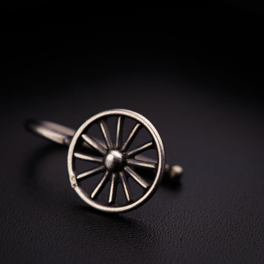 a silver ring with a wheel on it