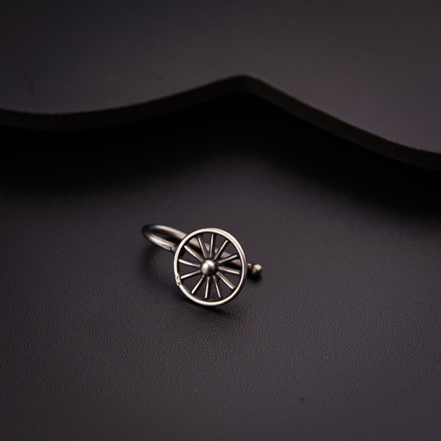 a close up of a ring with a wheel on it