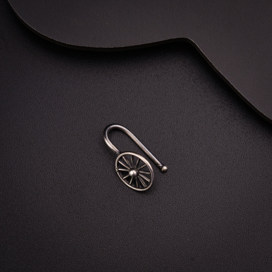 a metal hook with a wheel on it