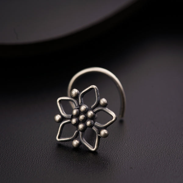 a silver ring with a flower on it