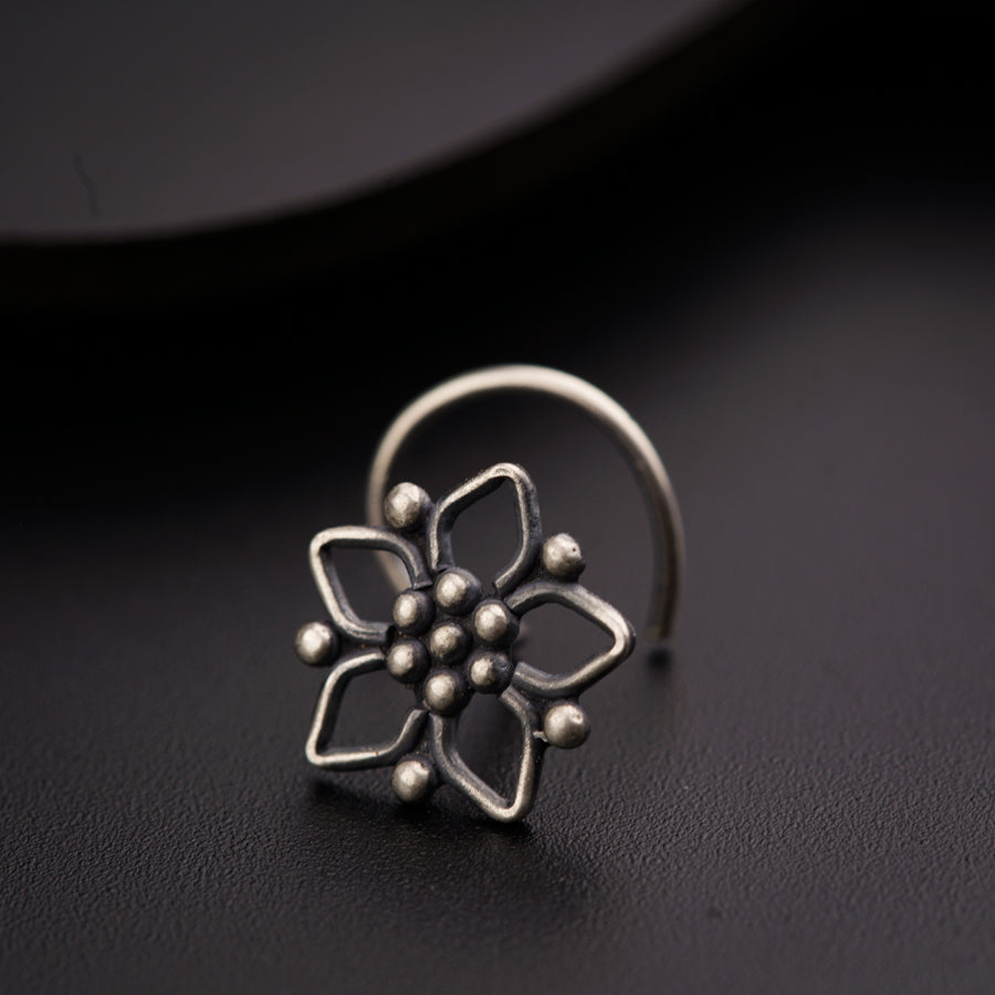 a silver ring with a flower on it