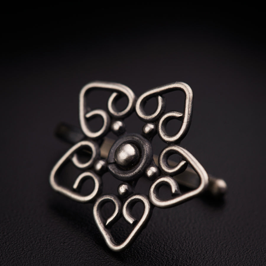 a close up of a metal object on a black surface