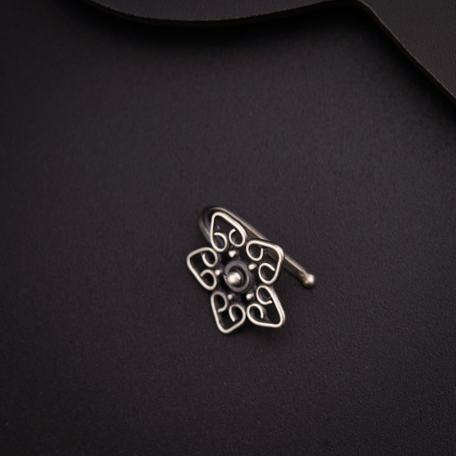 a close up of a metal object on a black surface