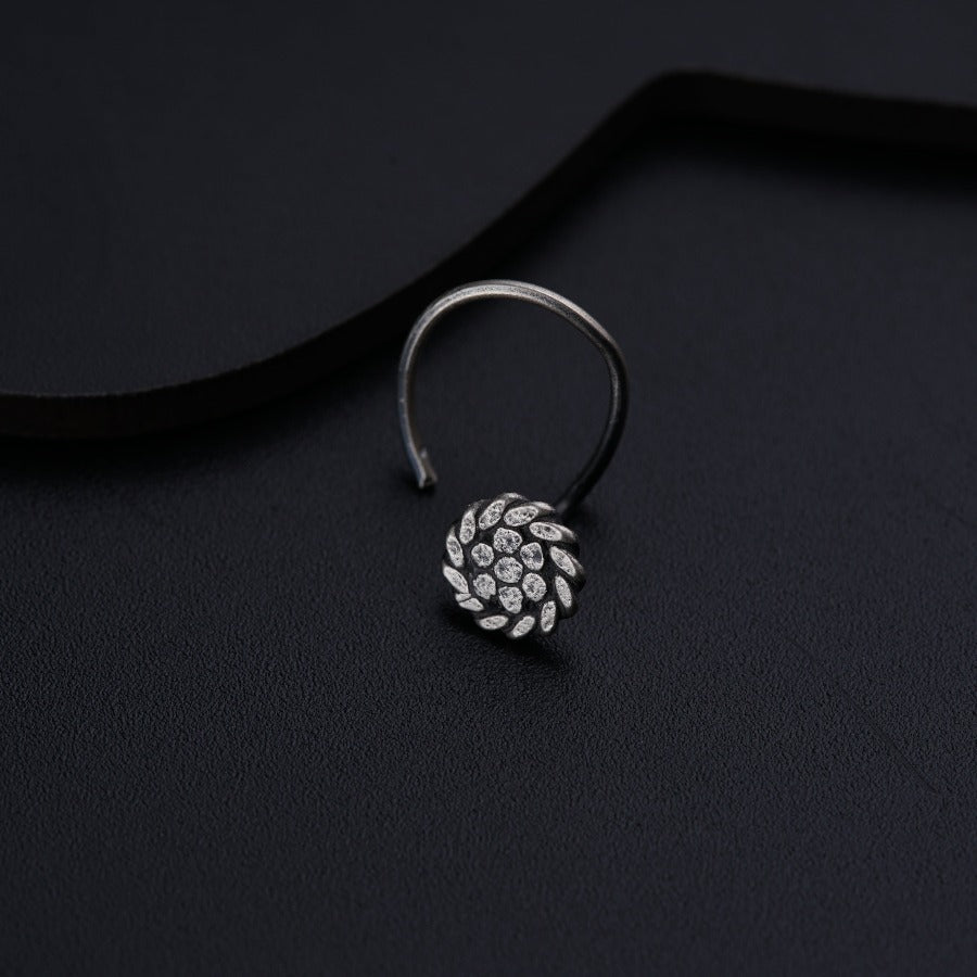 a close up of a ring on a black surface