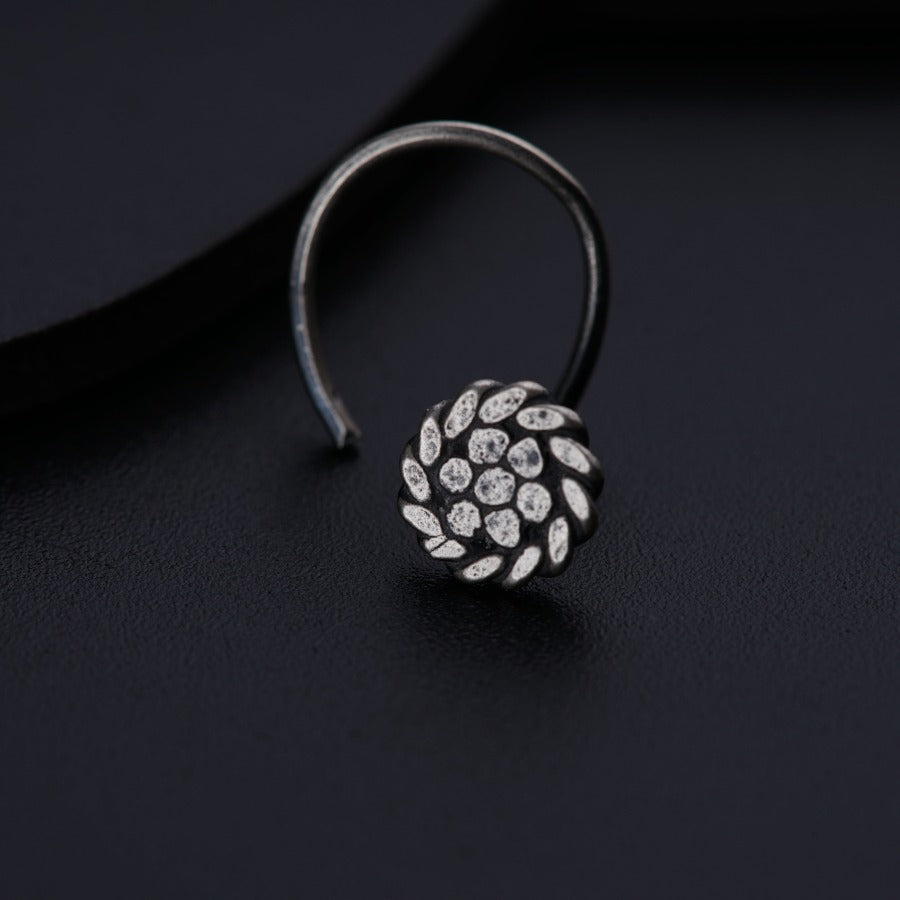 a close up of a ring on a black surface