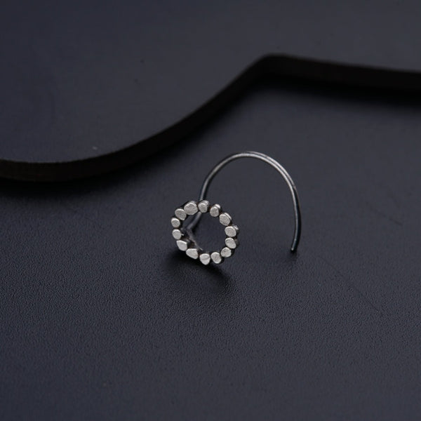 a close up of a pair of earrings on a black surface