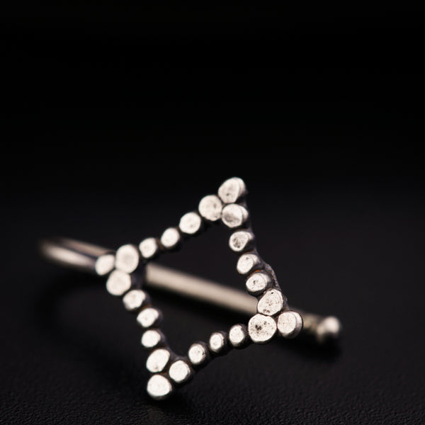 a close up of a metal object on a black surface
