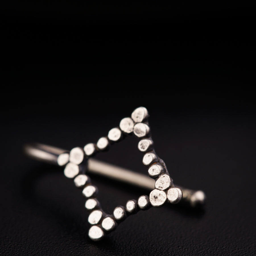 a close up of a metal object on a black surface