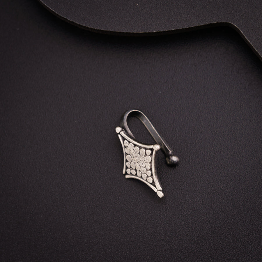 a close up of a metal object on a black surface