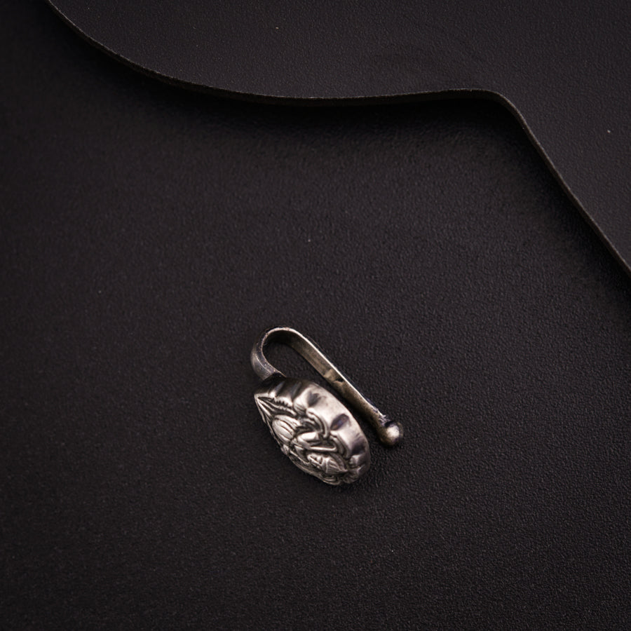 a metal object on a black surface