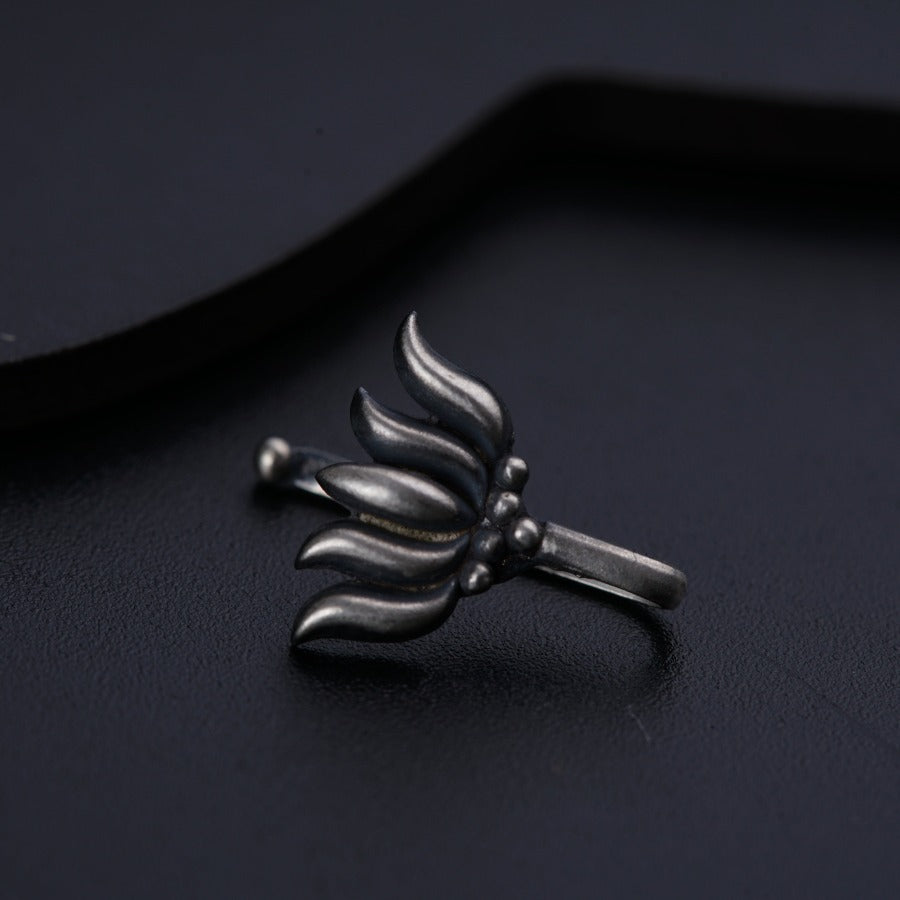 a silver ring with a flower design on it