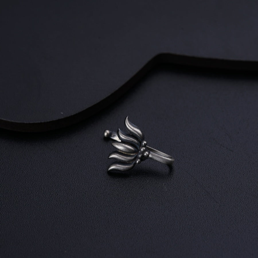 a silver ring sitting on top of a black surface