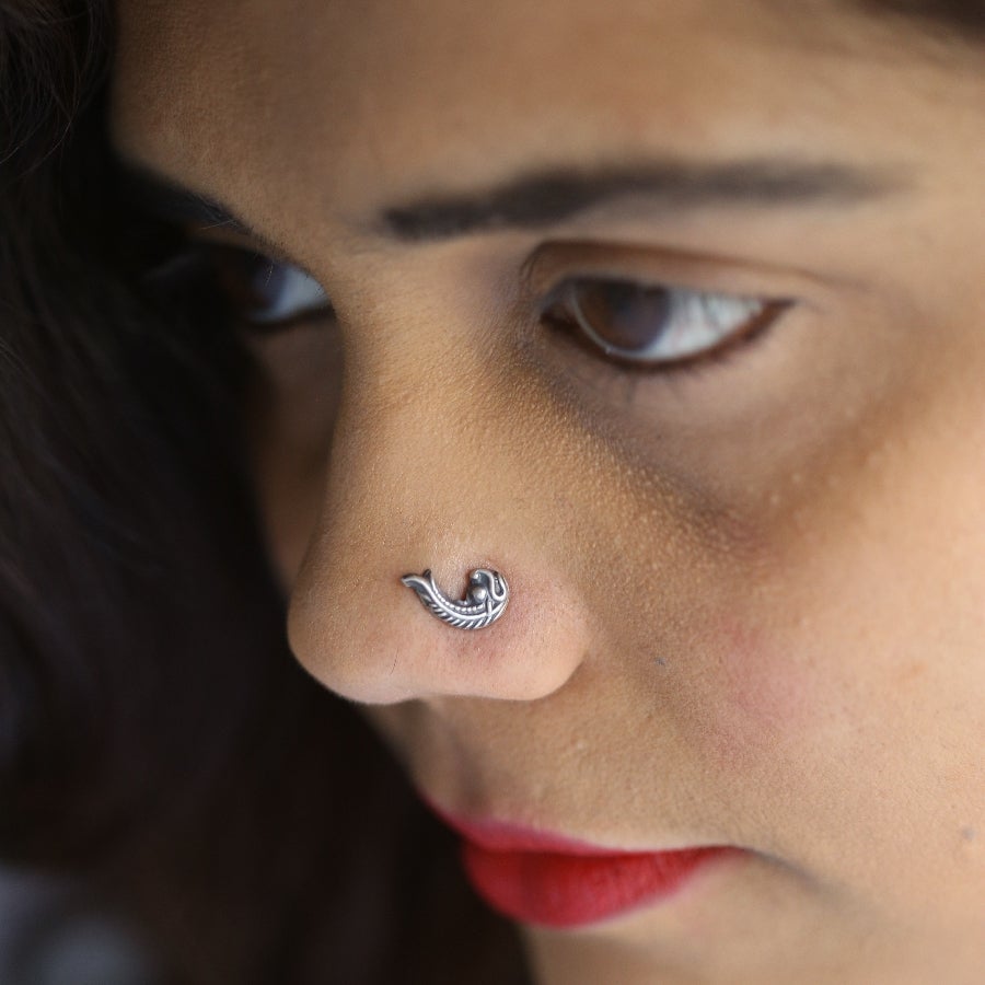 a close up of a person with a nose piercing