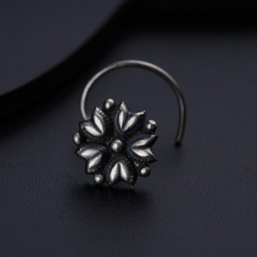 a close up of a ring on a black surface