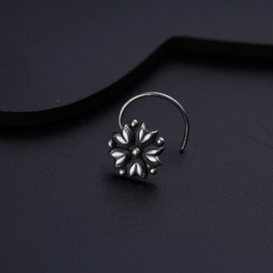 a close up of a pair of earrings on a black surface