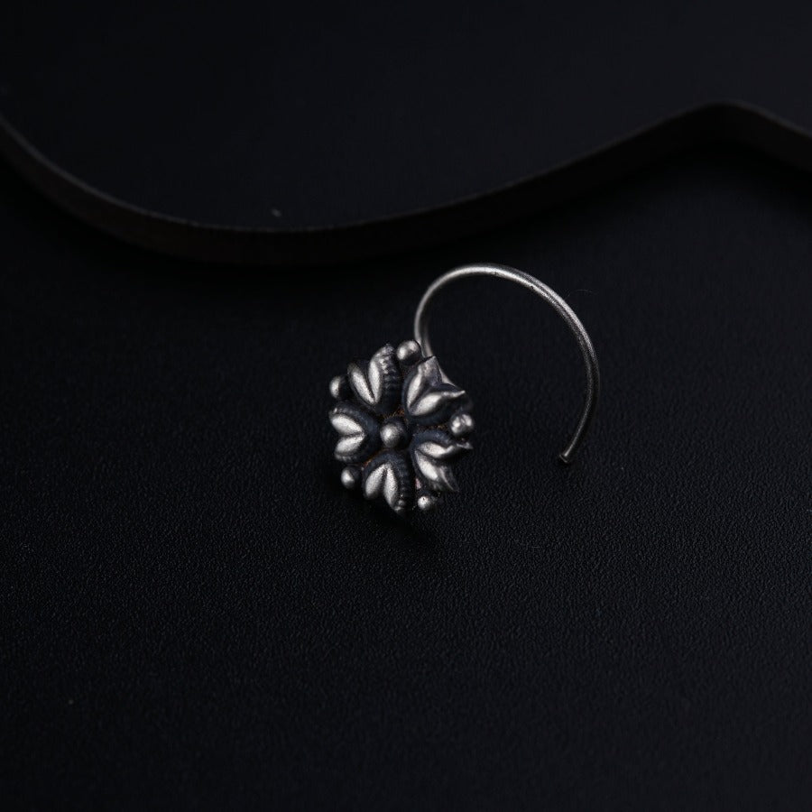 a close up of a pair of earrings on a black surface