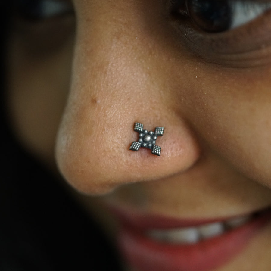 a close up of a person with a nose piercing