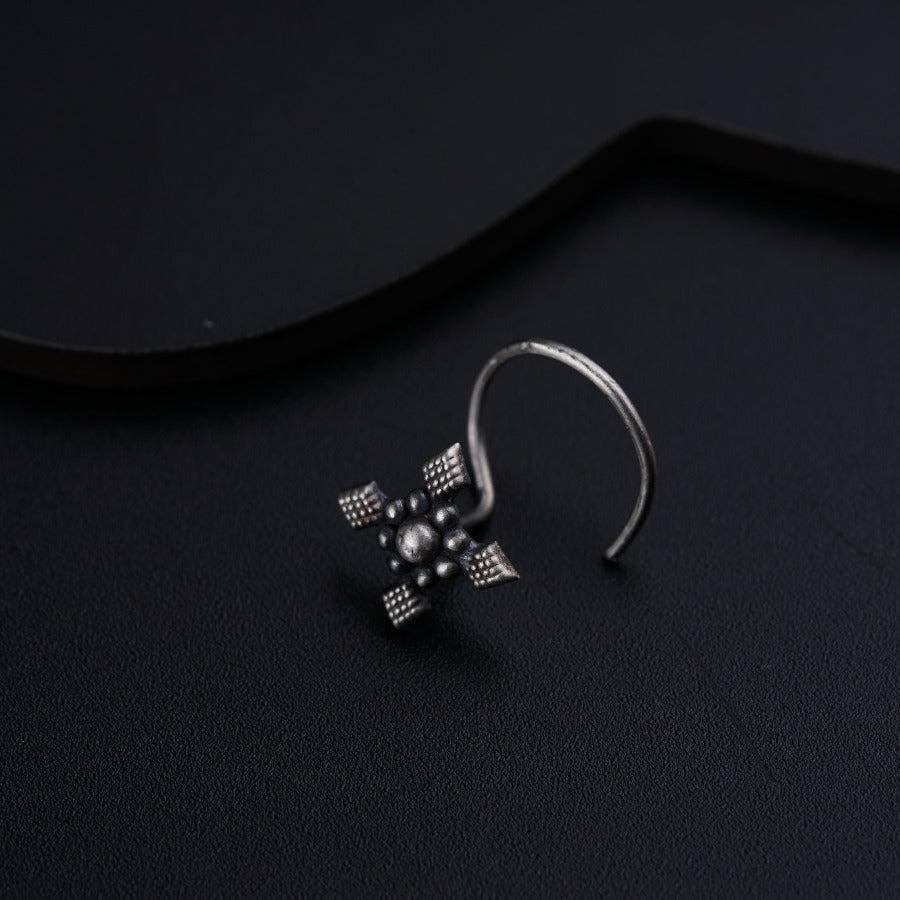 a close up of a pair of earrings on a black surface