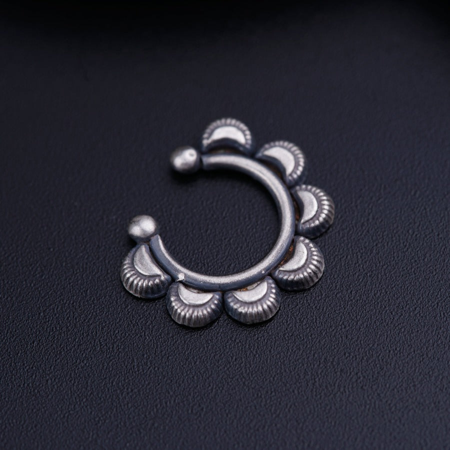 a close up of a metal object on a black surface