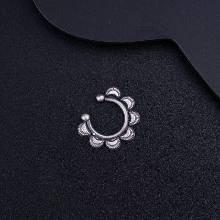 a close up of a metal object on a black surface