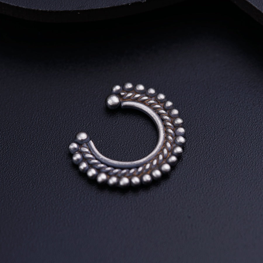 a close up of a metal object on a black surface