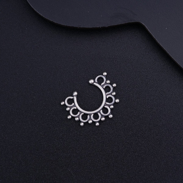 a close up of a metal object on a black surface