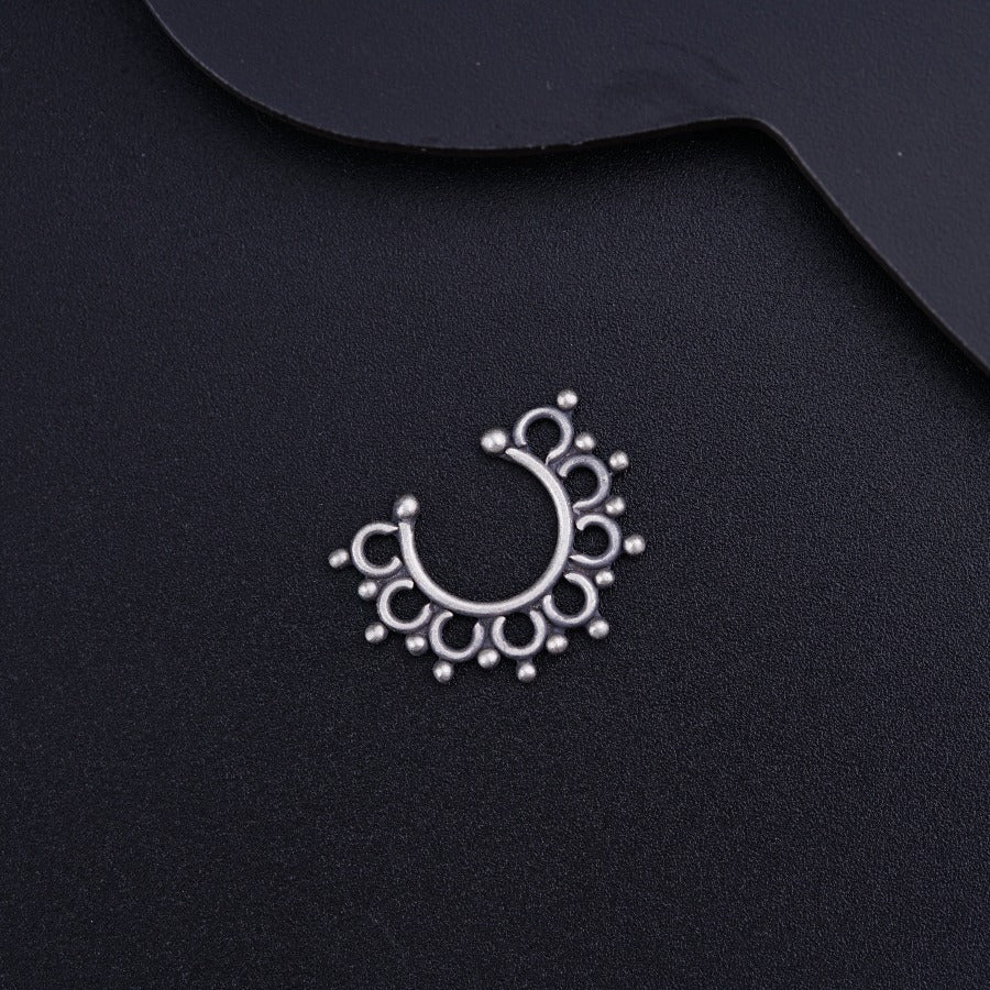 a close up of a metal object on a black surface