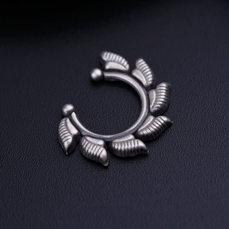 a close up of a metal object on a black surface