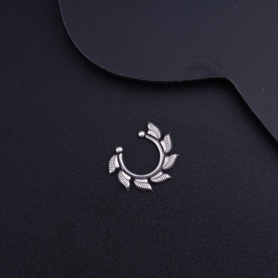 a close up of a metal object on a black surface