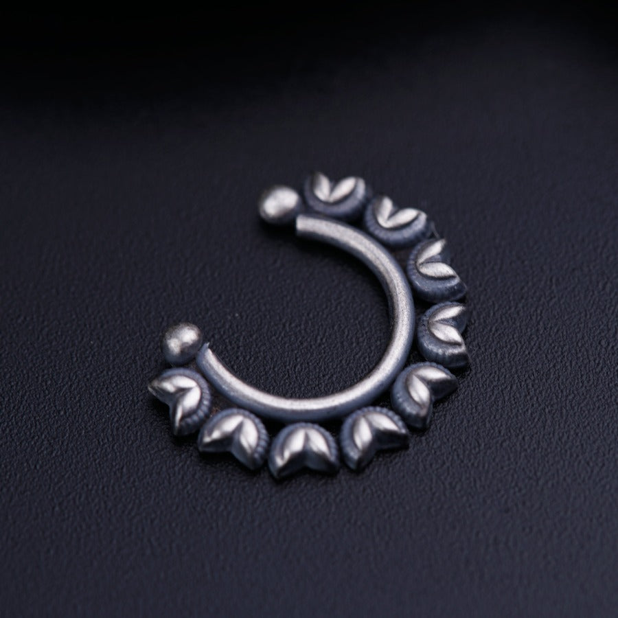 a close up of a metal object on a black surface