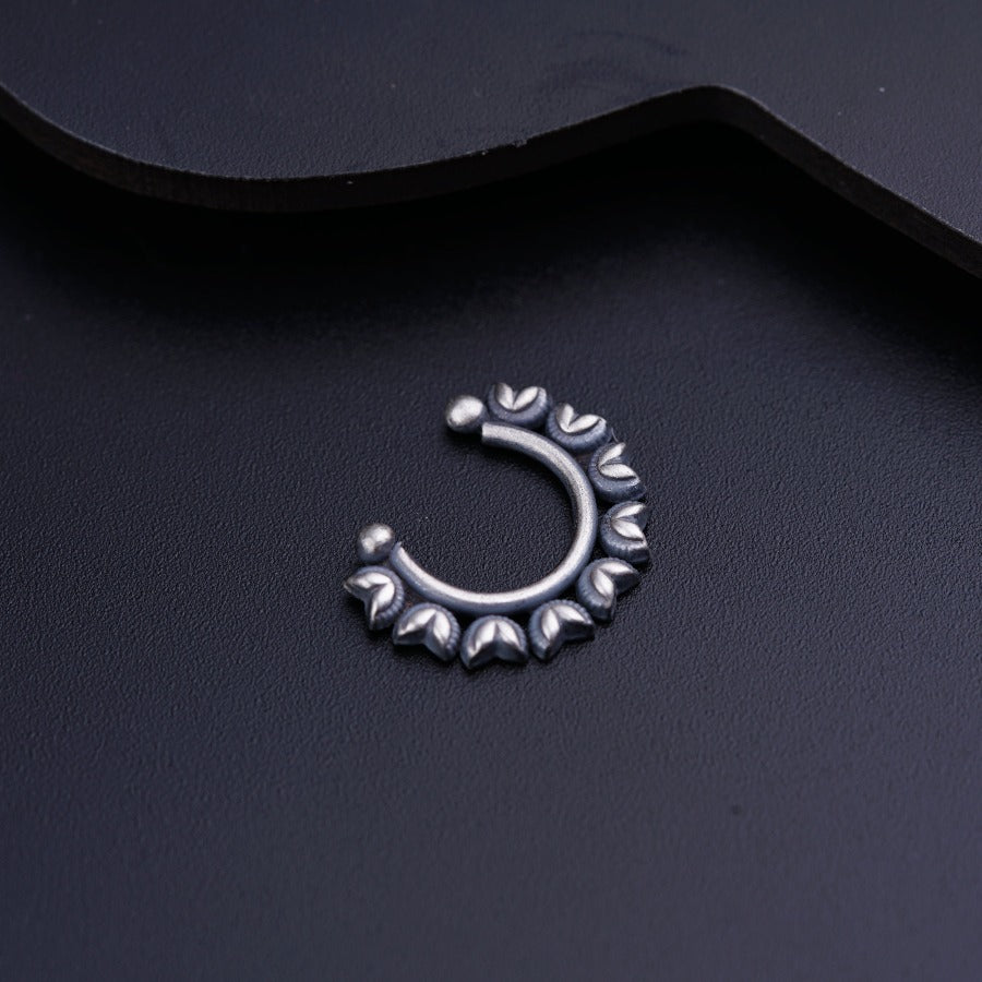 a close up of a metal object on a black surface