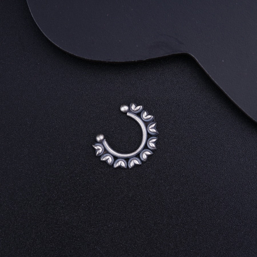 a close up of a metal object on a black surface