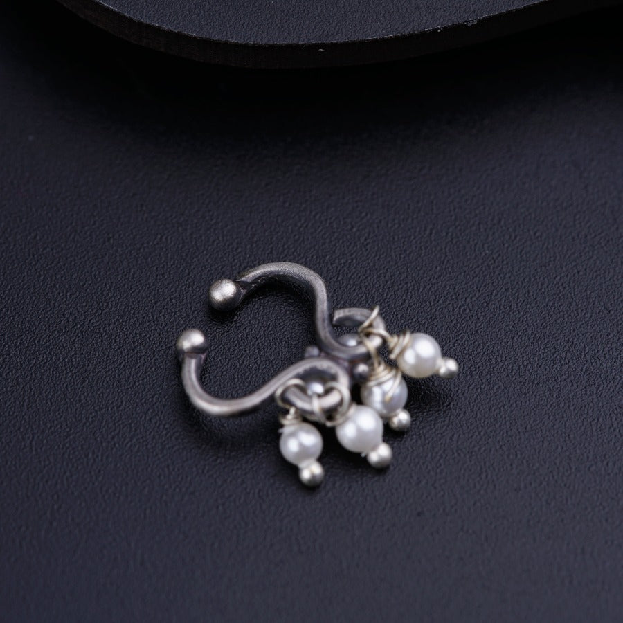 a close up of a pair of earrings on a black surface