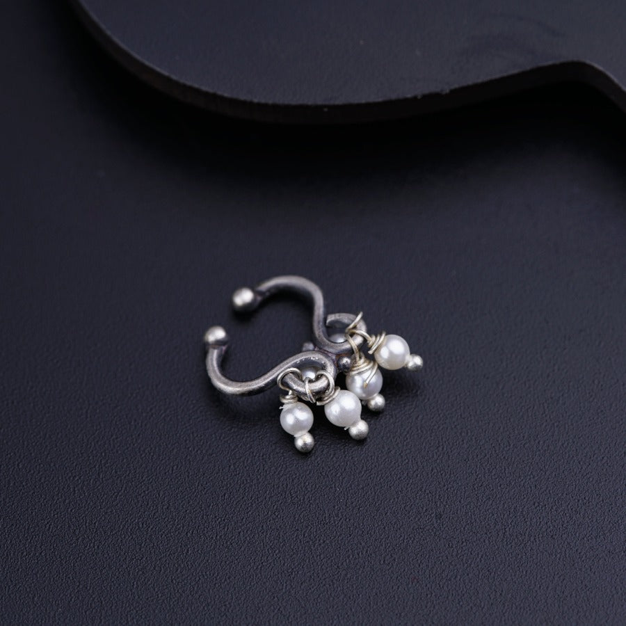 a close up of a pair of earrings on a black surface