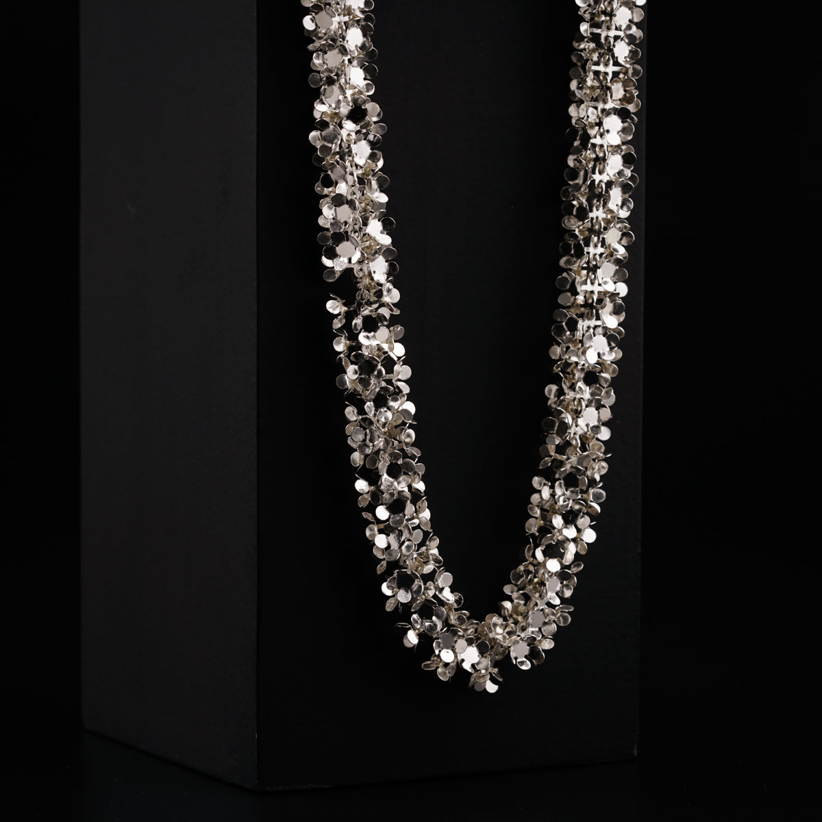 a necklace is displayed on a black box