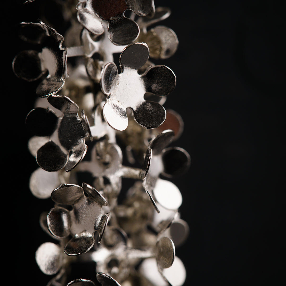 a bunch of metal discs hanging from a ceiling