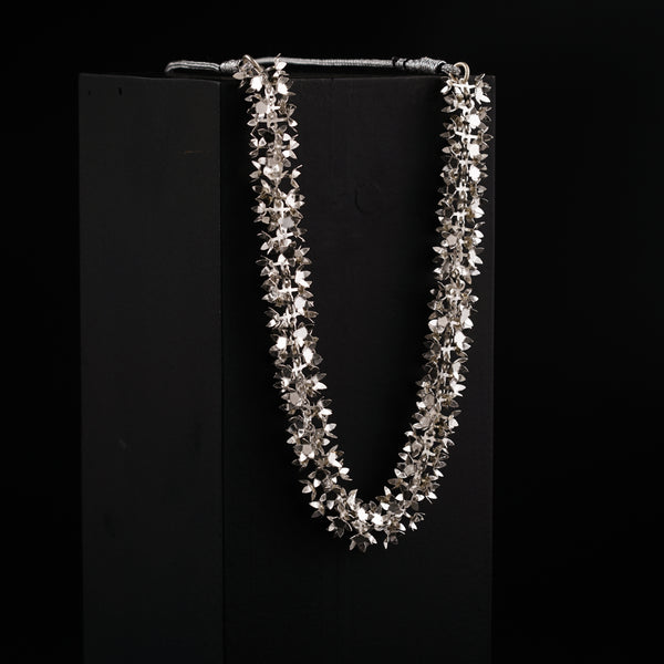 a necklace is displayed on a black background