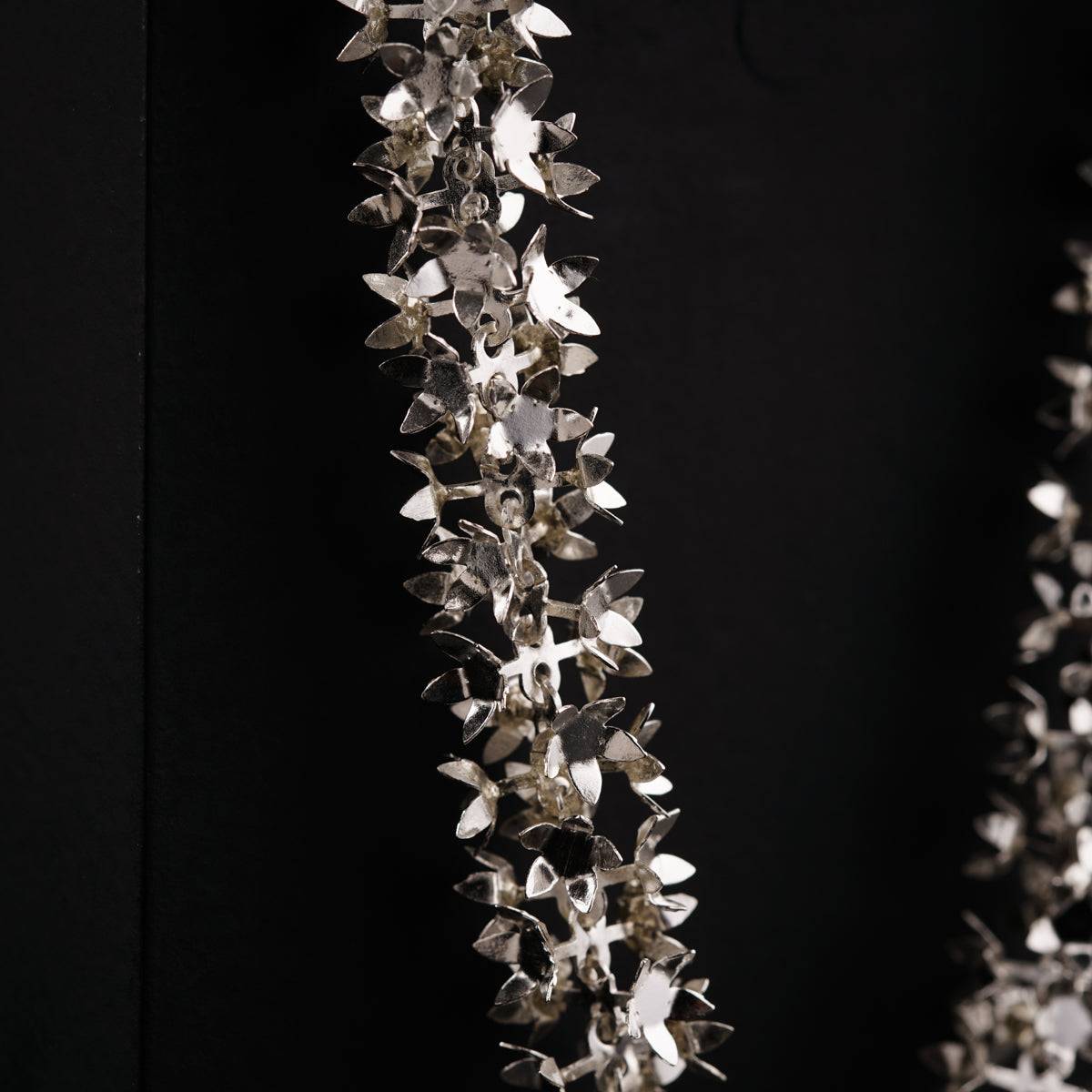 a close up of a necklace on a black background