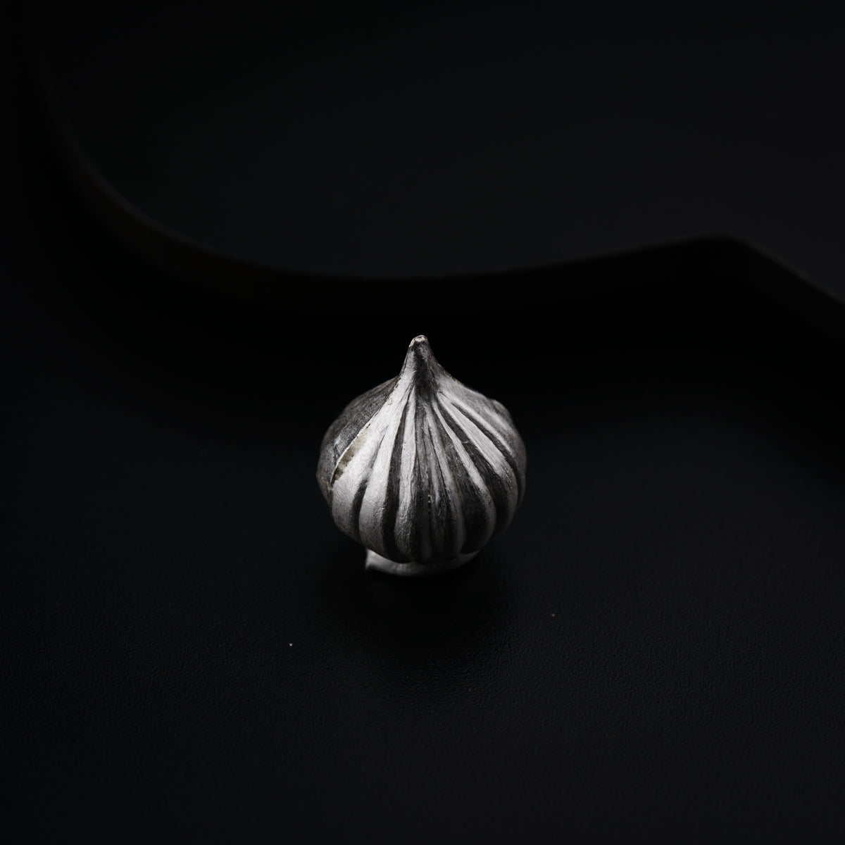 a close up of a sea shell on a black background