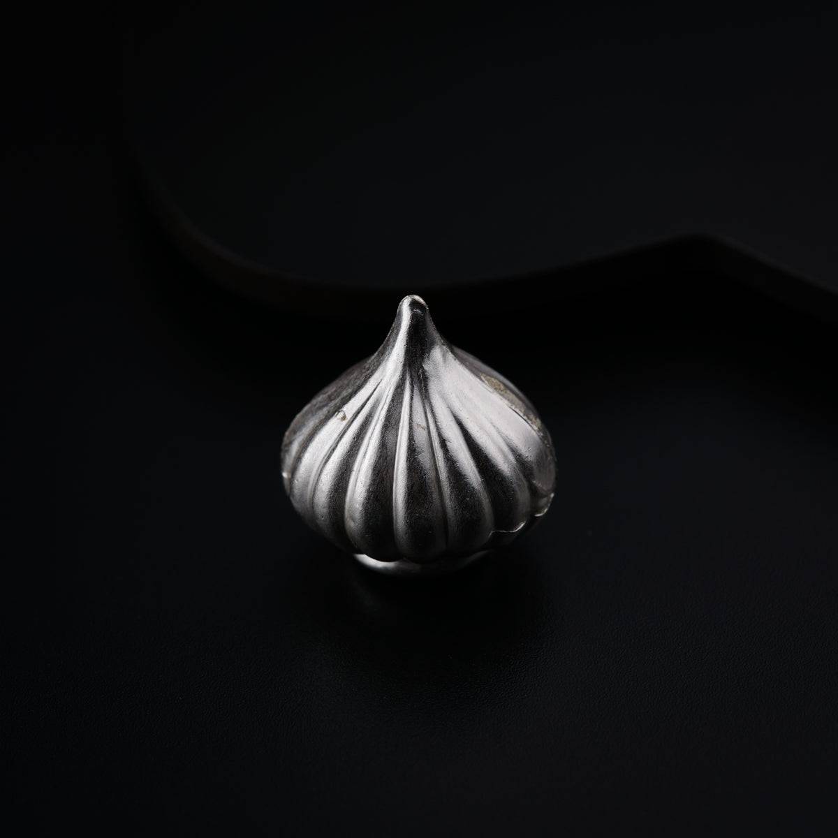 a close up of a metal object on a black surface