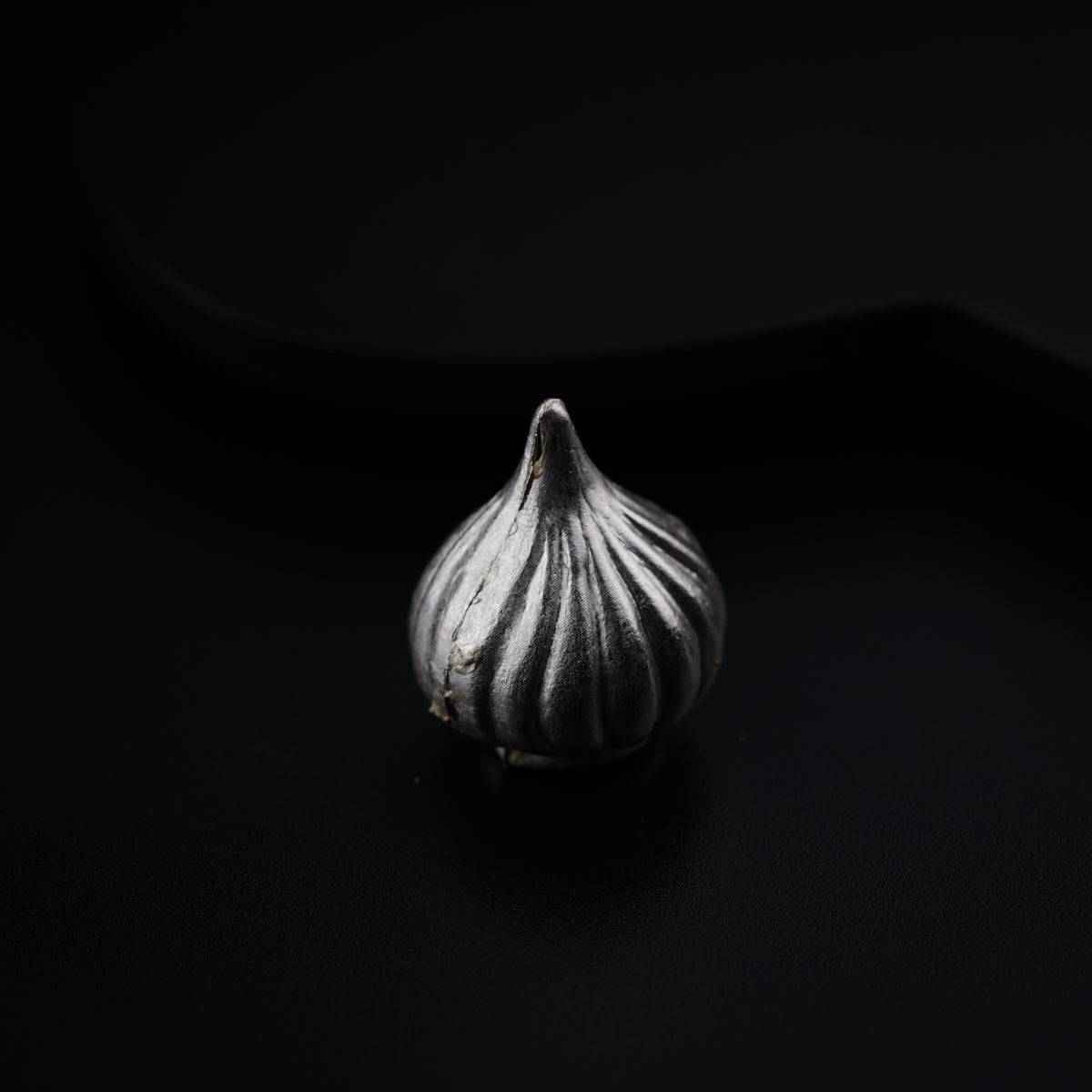 a close up of a garlic on a black background