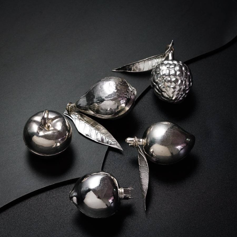 a group of silver ornaments sitting on top of a table